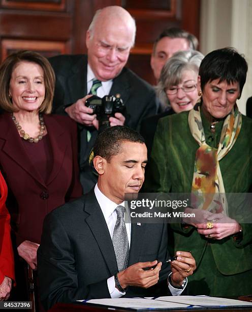 Sen. Patrick Leahy looks at his camera for the picture he took U.S. President Barack Obama signing the "Lilly Ledbetter Fair Pay Act duringn an event...