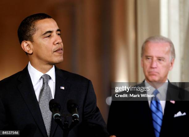 President Barack Obama speaks while flanked by Vice President Joseph Biden before signing the "Lilly Ledbetter Fair Pay Act duringn an event in the...