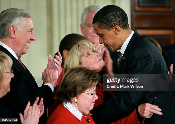 President Barack Obama hugs Lilly Ledbetter after signing the "Lilly Ledbetter Fair Pay Act during an event in the East Room of the White House...