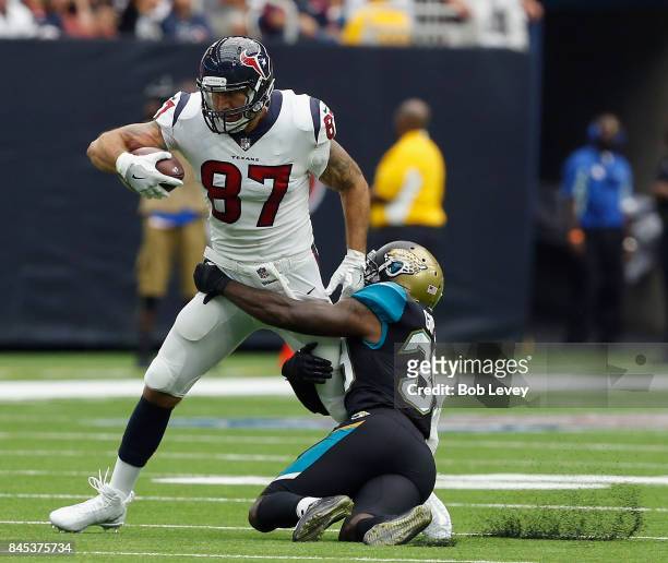 Fiedorowicz of the Houston Texans is tackled by Tashaun Gipson of the Jacksonville Jaguars at NRG Stadium on September 10, 2017 in Houston, Texas.
