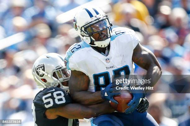 Tight End Delanie Walker of the Tennessee Titans makes a catch defended by linebacker Tyrell Adams of the Oakland Raiders in the second half at...
