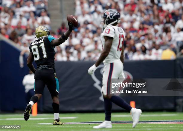 Yannick Ngakoue of the Jacksonville Jaguars celebrates a fumble recovery in the fouth quarter as Braxton Miller of the Houston Texans walks to the...