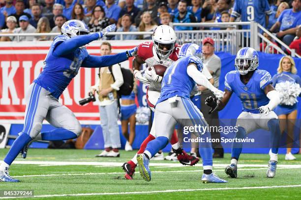 Arizona Cardinals running back David Johnson catches the ball and is tackled by Detroit Lions defensive end Jeremiah Ledbetter and Detroit Lions free...