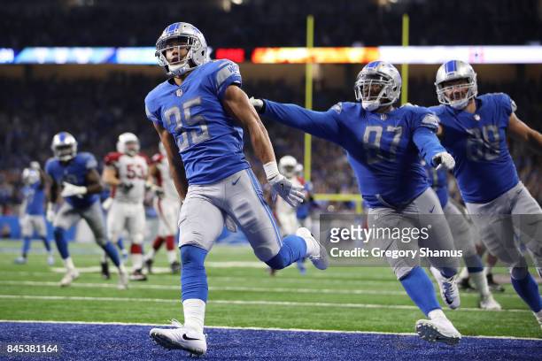 Miles Killebrew of the Detroit Lions celebrates a fourth quarter touchdown with Armonty Bryant after he intercepts a pass while playing the Arizona...