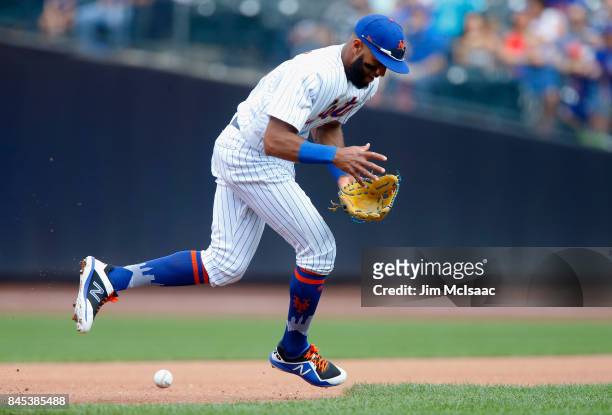 Amed Rosario of the New York Mets can't come up up with a ball hit for an infield single in the fourth inning by Scott Schebler of the Cincinnati...