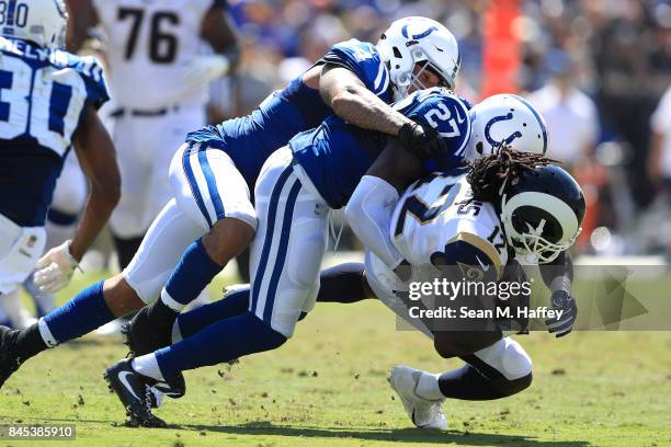 Antonio Morrison and Nate Hairston of the Indianapolis Colts tackle Sammy Watkins of the Los Angeles Rams during the first half of a game at Los...