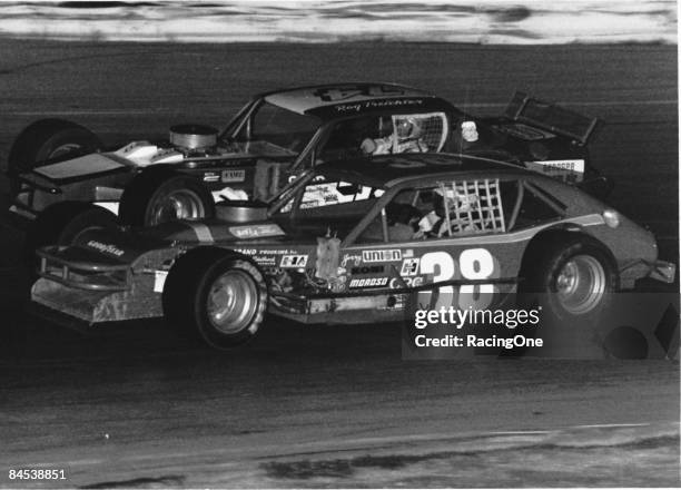 Jerry Cook driver of the Ford Pinto modified races with fellow legend Roger Treichler on a short track during the NASCAR Modified series circa 1970's.