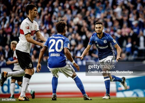 Nabil Bentaleb of Schalke celebrates with team mates after scoring his teams first goal during the Bundesliga match between FC Schalke 04 and VfB...