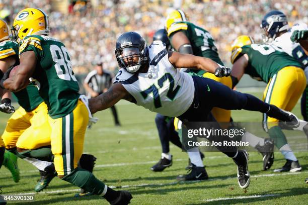 Michael Bennett of the Seattle Seahawks attempts to tackle Ty Montgomery of the Green Bay Packers during the first half at Lambeau Field on September...