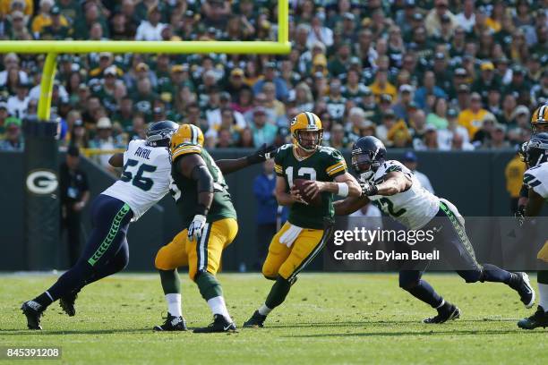 Michael Bennett of the Seattle Seahawks sacks Aaron Rodgers of the Green Bay Packers during the first half at Lambeau Field on September 10, 2017 in...