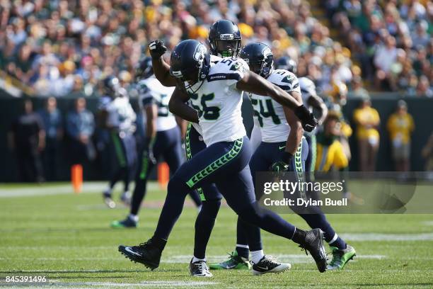 Cliff Avril of the Seattle Seahawks celebrates after sacking Aaron Rodgers of the Green Bay Packers during the first half at Lambeau Field on...