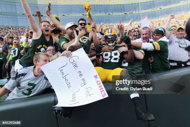 Ty Montgomery of the Green Bay Packers celebrates with fans after scoring a 6-yard rushing touchdown during the third quarter against the Seattle...