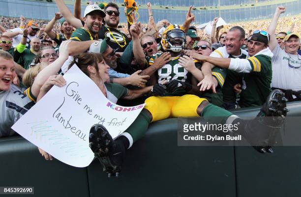 Ty Montgomery of the Green Bay Packers celebrates with fans after scoring a 6-yard rushing touchdown during the third quarter against the Seattle...