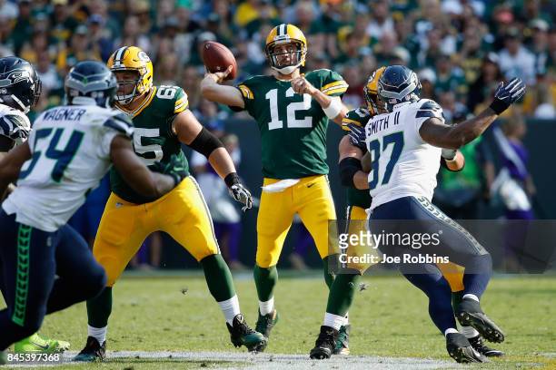 Aaron Rodgers of the Green Bay Packers throws a pass during the first half against the Seattle Seahawks at Lambeau Field on September 10, 2017 in...