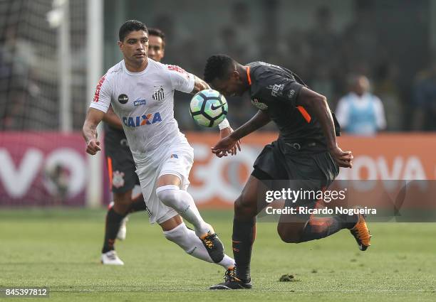 Renato of Santos battles for the ball with Jo of Corinthians during the match between Santos and Corinthians as a part of Campeonato Brasileiro 2017...