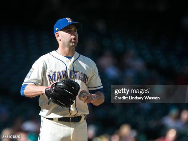 Marc Rzepczynski of the Seattle Mariners reacts after allowing Justin Upton of the Los Angeles Angels of Anaheim to score on his wild pitch in the...