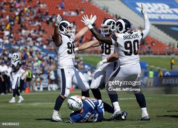 Michael Brockers, Matt Longacre and Connor Barwin of the Los Angeles Rams celebrate after a sack against Scott Tolzien of the Indianapolis Colts...
