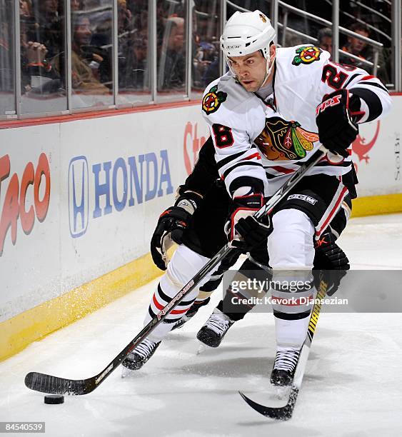 Craig Adams of the Chicago Blackhawks controls the puck against Anaheim Ducks during the first period of the game at the Honda Center on January 28,...