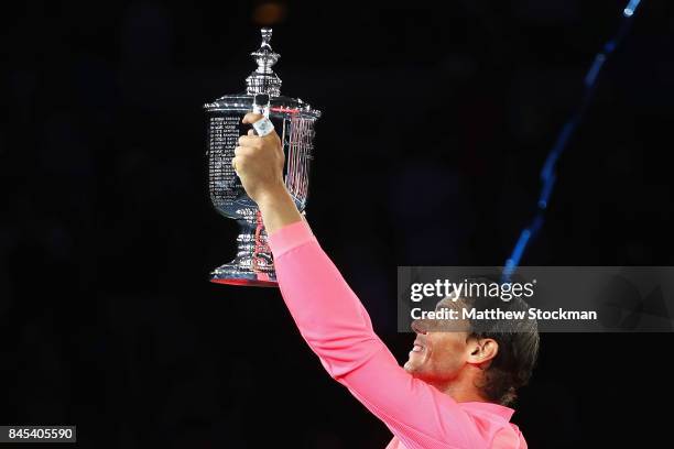 Rafael Nadal of Spain poses with the championship trophy during the trophy ceremony after their Men's Singles Finals match on Day Fourteen of the...