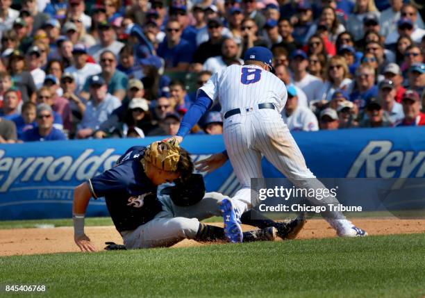 Chicago Cubs second baseman Ian Happ is in a rundown with Milwaukee Brewers right field Hernan Perez in the sixth inning and the Cubs eventually...