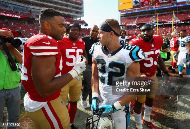 Christian McCaffrey of the Carolina Panthers talks to Reuben Foster and Solomon Thomas of the San Francisco 49ers after their game at Levi's Stadium...