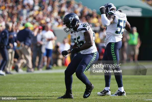 Cliff Avril of the Seattle Seahawks celebrates after sacking Aaron Rodgers of the Green Bay Packers during the first half at Lambeau Field on...