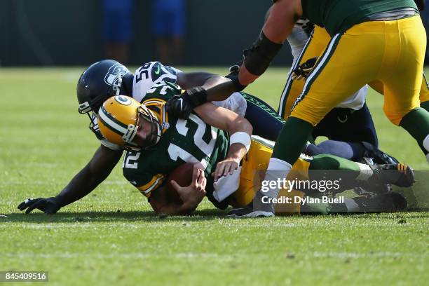 Cliff Avril of the Seattle Seahawks sacks Aaron Rodgers of the Green Bay Packers during the first quarter at Lambeau Field on September 10, 2017 in...