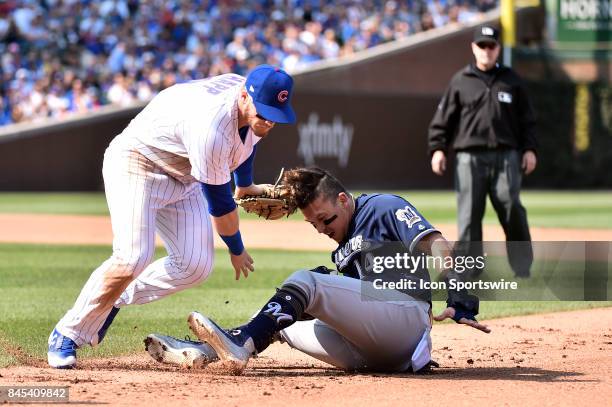 Milwaukee Brewers' Hernan Perez is caught in a pickle and tagged out by Chicago Cubs second baseman Ian Happ during the game between the Milwaukee...