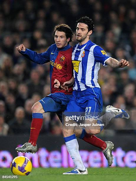 Lionel Messi of Barcelona duels for the ball with Daniel Jarque of Espanyol during the Copa del Rey quarter final second leg match between Barcelona...