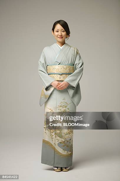 woman in kimono, portrait, studio shot - kimono stockfoto's en -beelden