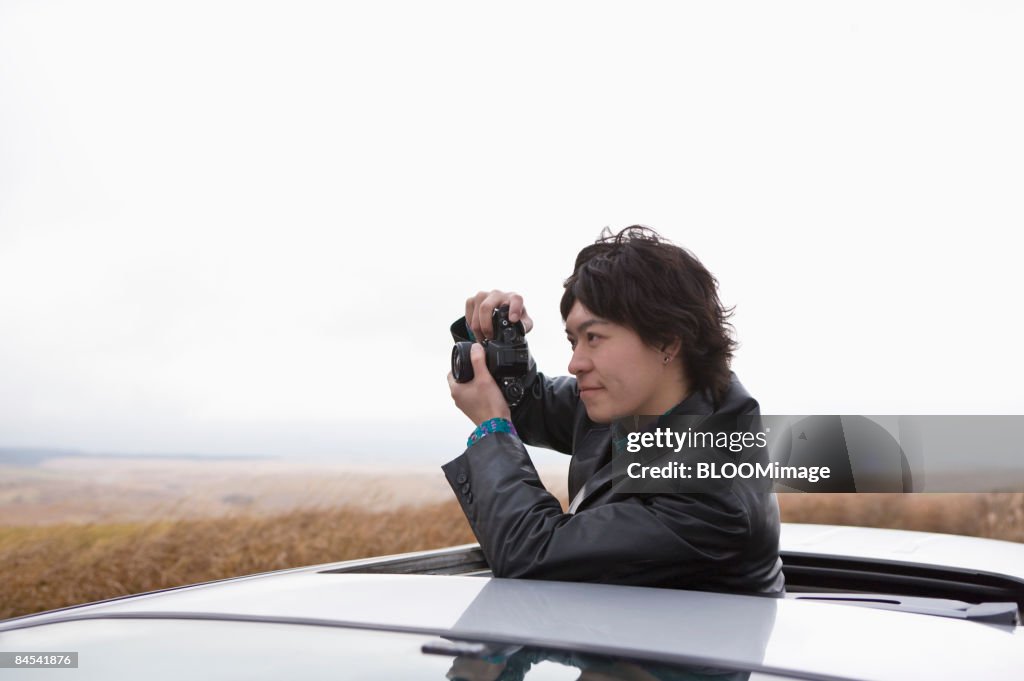 Man taking picture, side view