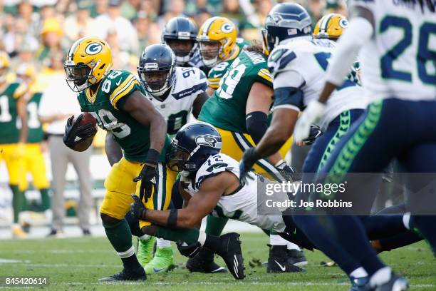 Michael Bennett of the Seattle Seahawks attempts to tackle Ty Montgomery of the Green Bay Packers during the fourth quarter at Lambeau Field on...