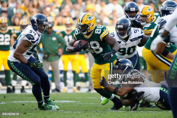 Michael Bennett of the Seattle Seahawks attempts to tackle Ty Montgomery of the Green Bay Packers during the fourth quarter at Lambeau Field on...