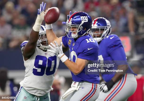 Eli Manning of the New York Giants is sacked for a loss by Demarcus Lawrence of the Dallas Cowboys in the first quarter at AT&T Stadium on September...