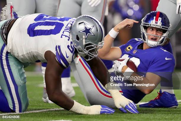 Eli Manning of the New York Giants is sacked for a loss by Demarcus Lawrence of the Dallas Cowboys in the first quarter at AT&T Stadium on September...