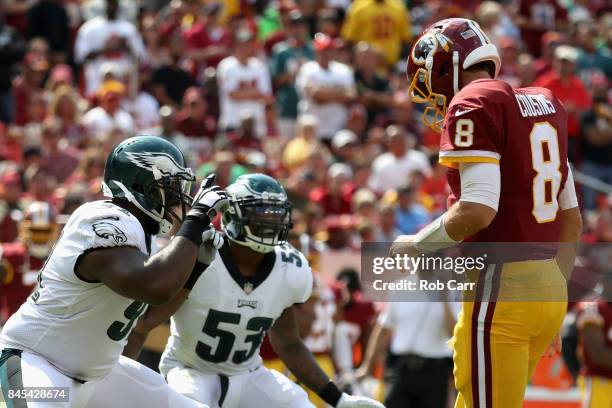 Fletcher Cox and outside linebacker Nigel Bradham of the Philadelphia Eagles celebrate after sacking quarterback Kirk Cousins of the Washington...