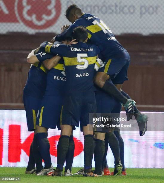 Dario Benedetto of Boca Juniors celebrates with teammates after scoring the first goal of his team during a match between Lanus and Boca Juniors as...