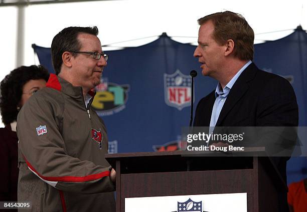 Tampa Bay Buccaneers Co-Chairman Bryan Glazer greets NFL Commissioner Roger Goodell, R, as Goodell announces a $1 million donation to the Tampa Bay...