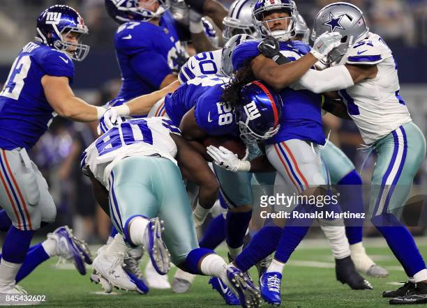 DeMarcus Lawrence of the Dallas Cowboys stops the carry by Paul Perkins of the New York Giants in the first quarter at AT&T Stadium on September 10,...
