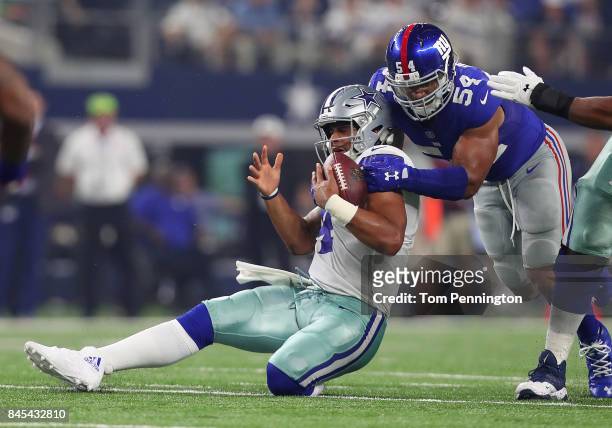 Dak Prescott of the Dallas Cowboys gets sacked by Olivier Vernon of the New York Giants in the second quarter of a game at AT&T Stadium on September...