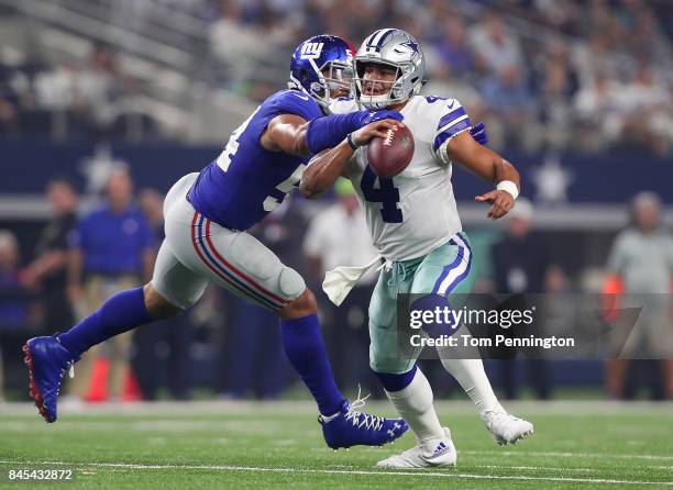 Dak Prescott of the Dallas Cowboys gets sacked by Olivier Vernon of the New York Giants in the second quarter of a game at AT&T Stadium on September...