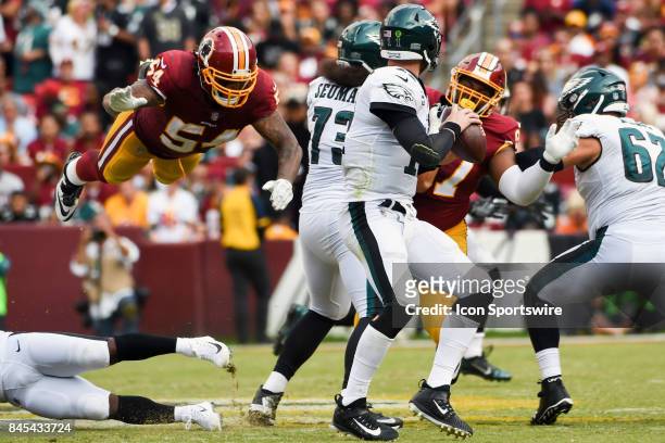 Washington Redskins inside linebacker Mason Foster leaps in the air to try and tackle Philadelphia Eagles quarterback Carson Wentz on September 10 at...