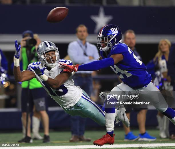 Brice Butler of the Dallas Cowboys dives for a pass against the efforts of Eli Apple of the New York Giants in the first half of a game at AT&T...