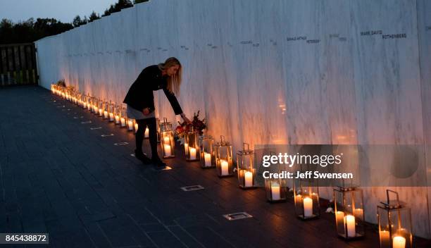 Woman adjusts an bouquet of flowers at Flight 93 National MemorialÕs annual Luminaria on the eve of 16th Anniversary ceremony of the September 11th...