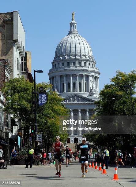 Competitors run down State Street during the Marathon portion of the Ironman Madison on September 10, 2017 in Madison, Wisconsin.
