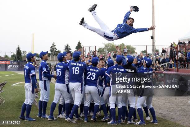 Members of the Korean National team celebrate prior to the medal ceremony during the WBSC U-18 Baseball World Cup at Port Arthur Stadium on September...