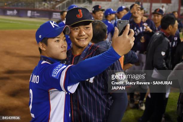 Kotaro Kiyomiya of Japan poses for a "selfie" with Choi Jun Woo of Korea following the WBSC U-18 Baseball World Cup medal ceremony at Port Arthur...