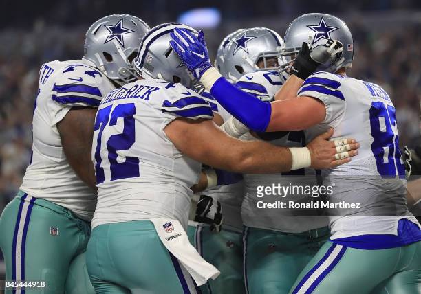 Tyron Smith of the Dallas Cowboys and Travis Frederick of the Dallas Cowboys celebrate the touchdown by Jason Witten of the Dallas Cowboys in the...