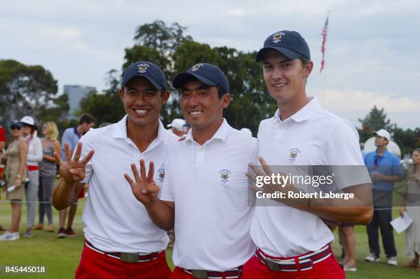 Collin Morikawa, Doug Ghim and Maverick McNealy pose together as the only 4 match winners after defeating the Great Britain and Ireland Team 19-7 at...