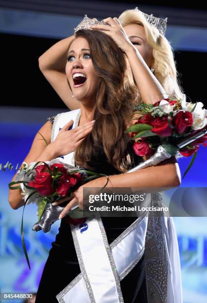 Miss North Dakota 2017 Cara Mund is crowned as Miss America 2018 by Miss America 2017 Savvy Shields during the 2018 Miss America Competition Show at...